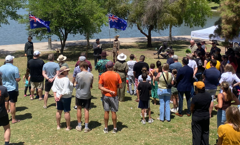 ANZAZ community members gathered at an outdoor event, showing people of various ages socializing and celebrating together